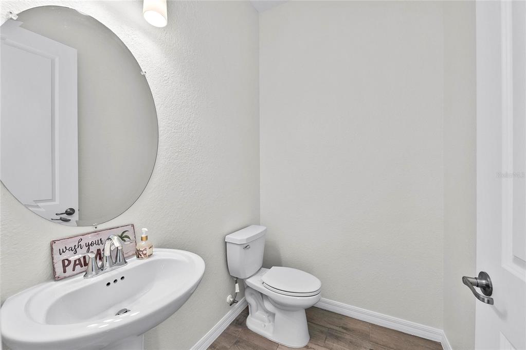 17341 Sandpearl Road Venice, FL 34293 - Photo 44 of 95 a bathroom with a sink a mirror and a toilet