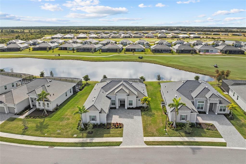 17341 Sandpearl Road Venice, FL 34293 - Photo 55 of 95 an aerial view of a house with a swimming pool yard and mountain view in back
