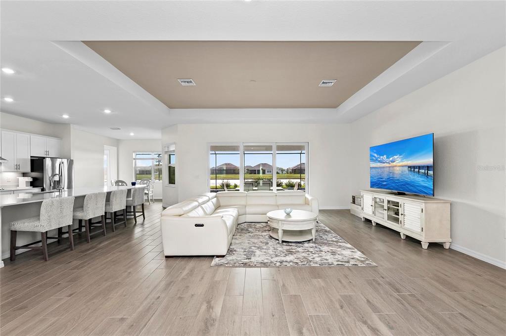 17341 Sandpearl Road Venice, FL 34293 - Photo 6 of 95 a living room with furniture and a flat screen tv