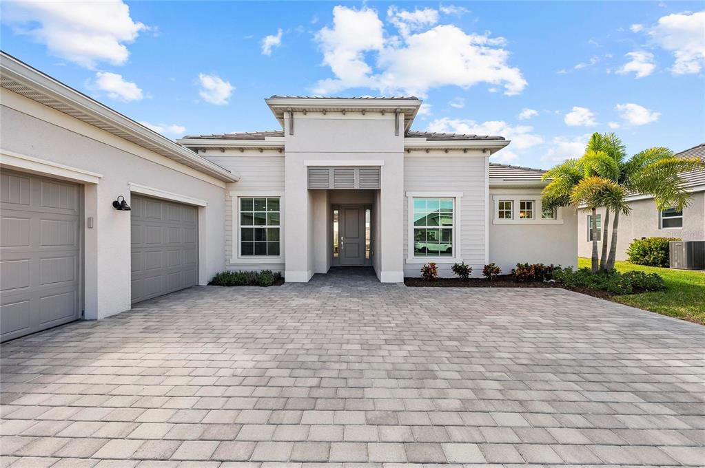 17341 Sandpearl Road Venice, FL 34293 - Photo 67 of 95 a view of a house with a yard and potted plants