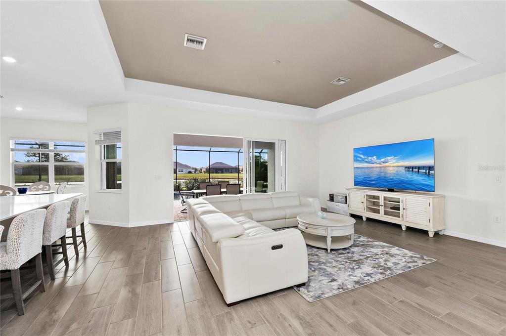 17341 Sandpearl Road Venice, FL 34293 - Photo 9 of 95 a living room with furniture and a flat screen tv