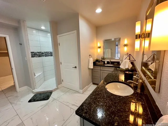 a bathroom with a sink double vanity and a mirror