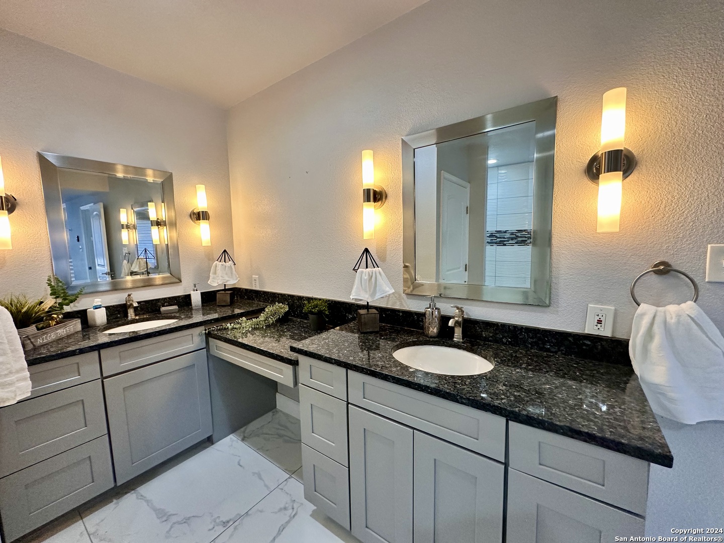 7701 Wurzbach Road, Unit 2301 San Antonio, TX 78229 - Photo 16 of 36 a bathroom with a granite countertop sink and a mirror