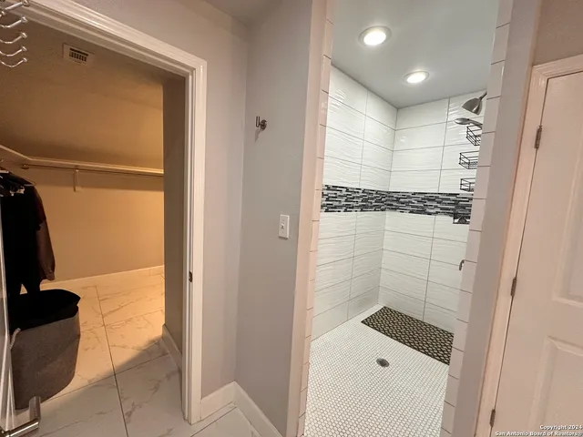 a bathroom with a shower and a sink