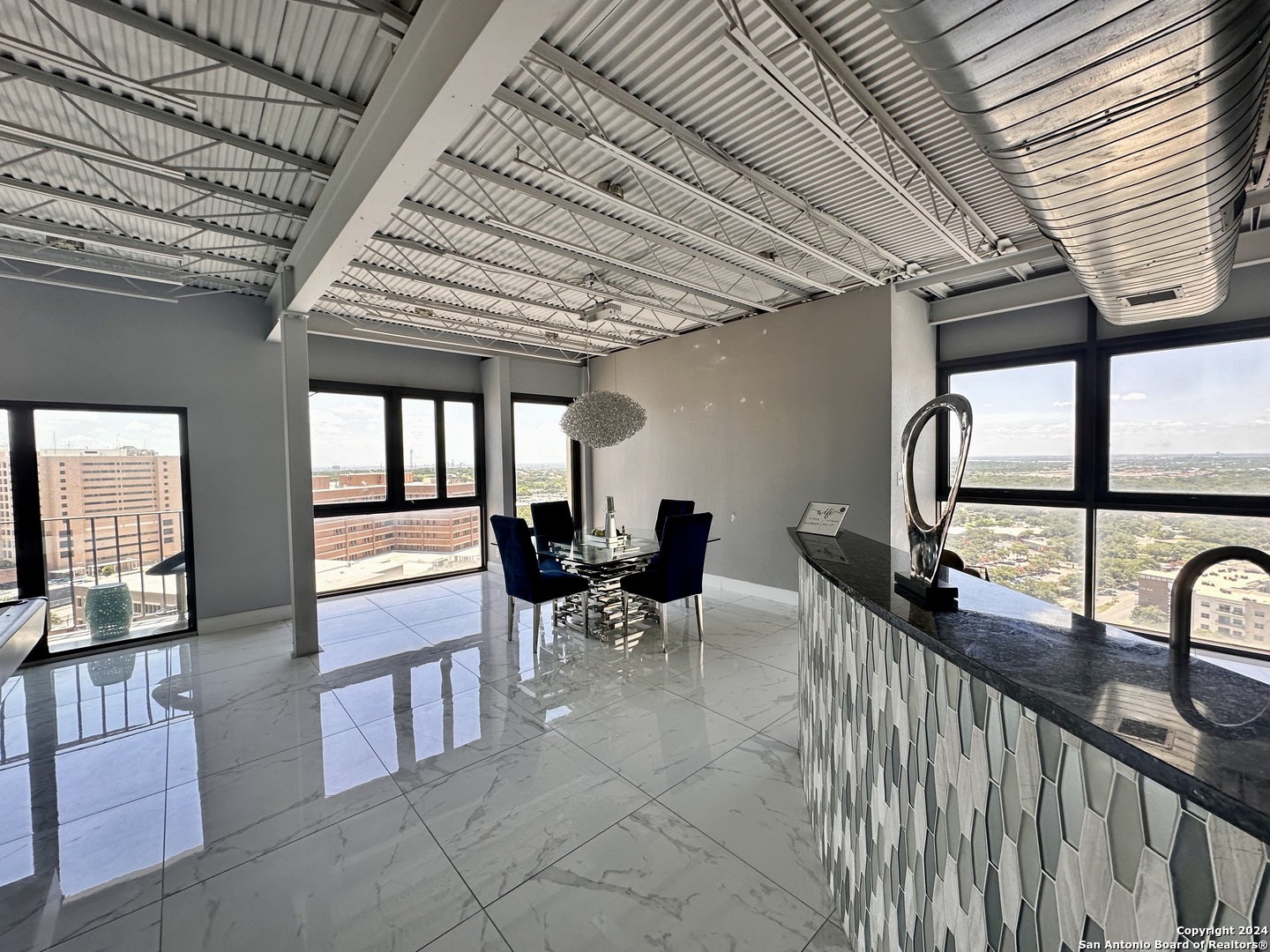 7701 Wurzbach Road, Unit 2301 San Antonio, TX 78229 - Photo 2 of 36 a view of a porch with chairs and couches with wooden floor
