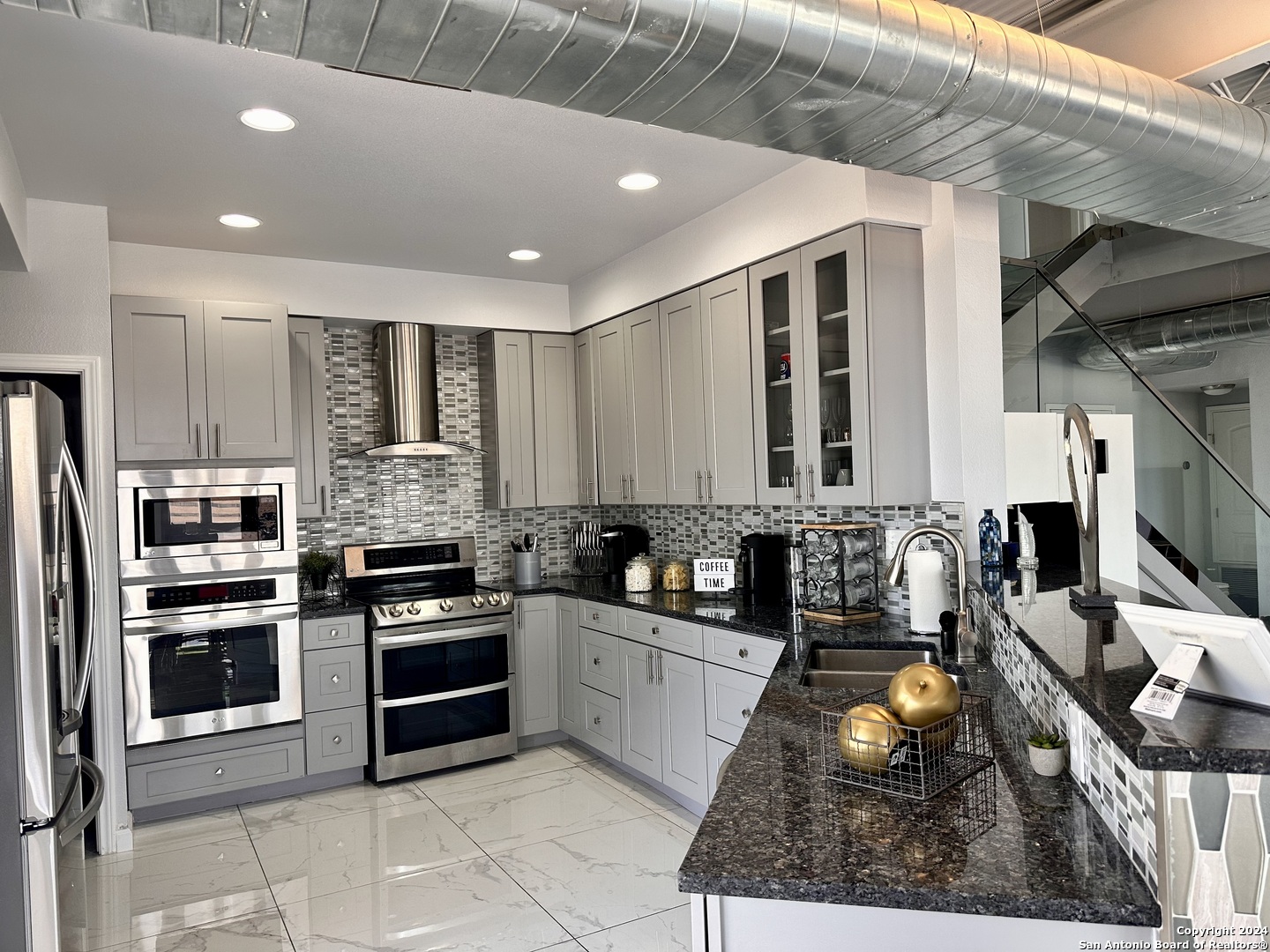 7701 Wurzbach Road, Unit 2301 San Antonio, TX 78229 - Photo 4 of 36 a kitchen with stainless steel appliances a stove sink and microwave