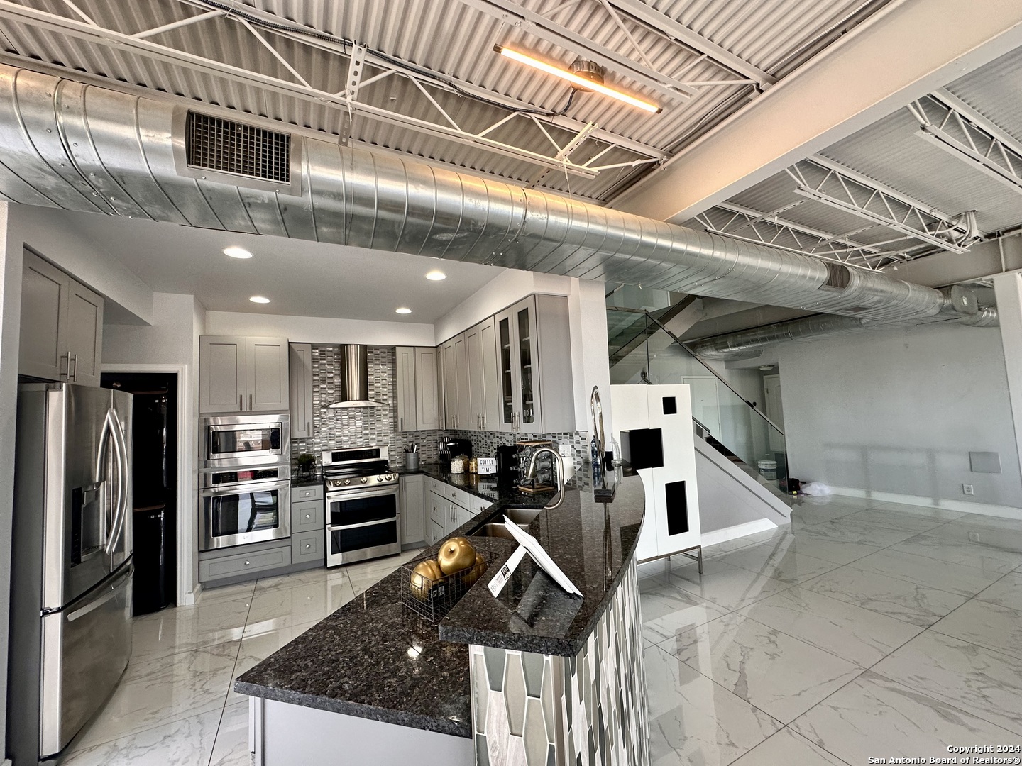 7701 Wurzbach Road, Unit 2301 San Antonio, TX 78229 - Photo 5 of 36 a kitchen with stainless steel appliances kitchen island granite countertop a refrigerator and a stove top oven