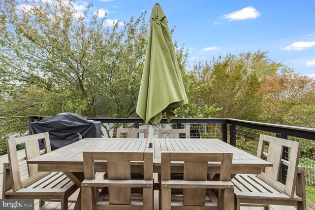 a view of a chair and table on the deck