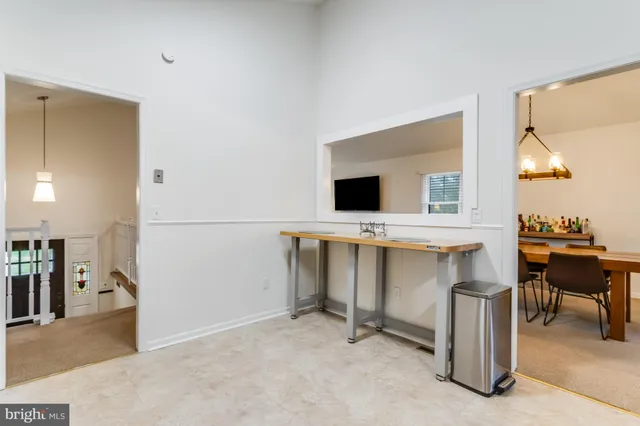a living room with furniture a flat screen tv and a large window