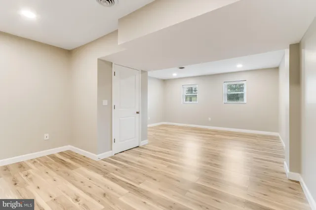 a large bed in a bedroom next to a window