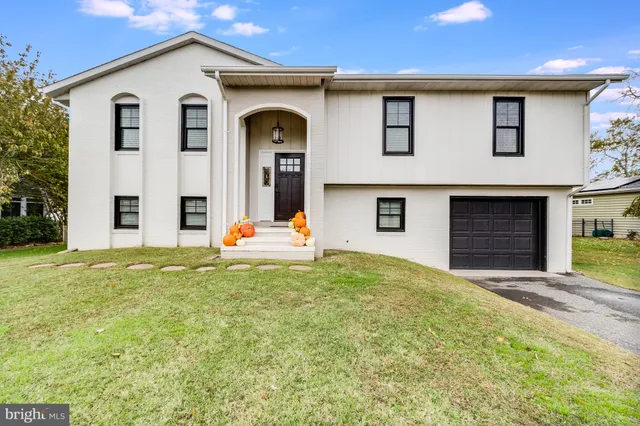 a big house with a big yard and large trees