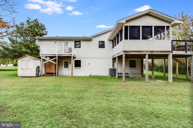 a patio with table and chairs and potted plants