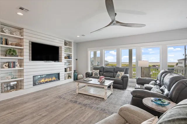 a kitchen with stainless steel appliances granite countertop a dining table chairs refrigerator and cabinets