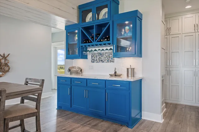 a bedroom with a large bed and a flat tv screen on dresser