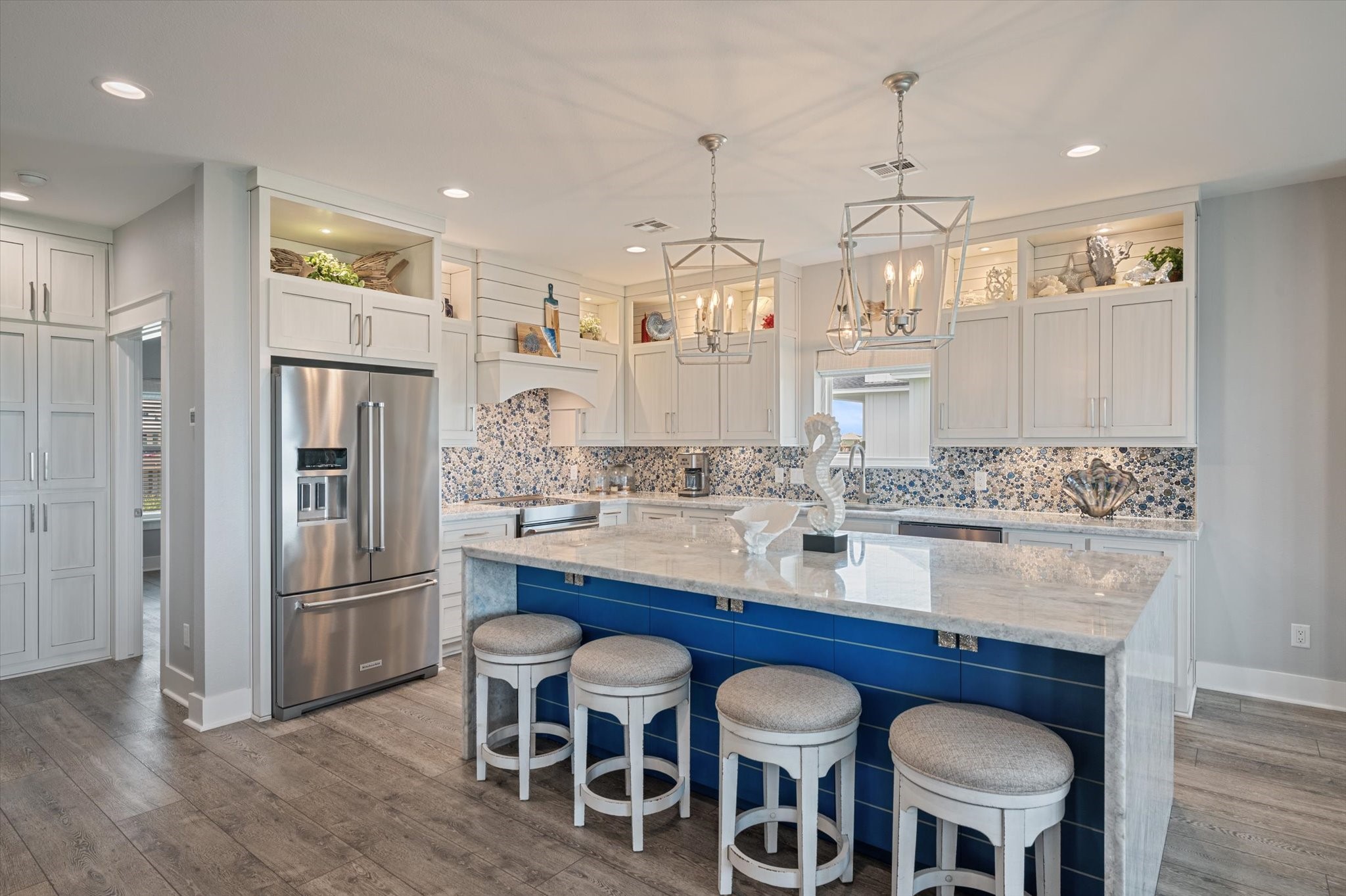 3701 Biscayne Beach Road Port Bolivar, TX 77650 - Photo 23 of 50 a kitchen with stainless steel appliances granite countertop a dining table chairs refrigerator and cabinets
