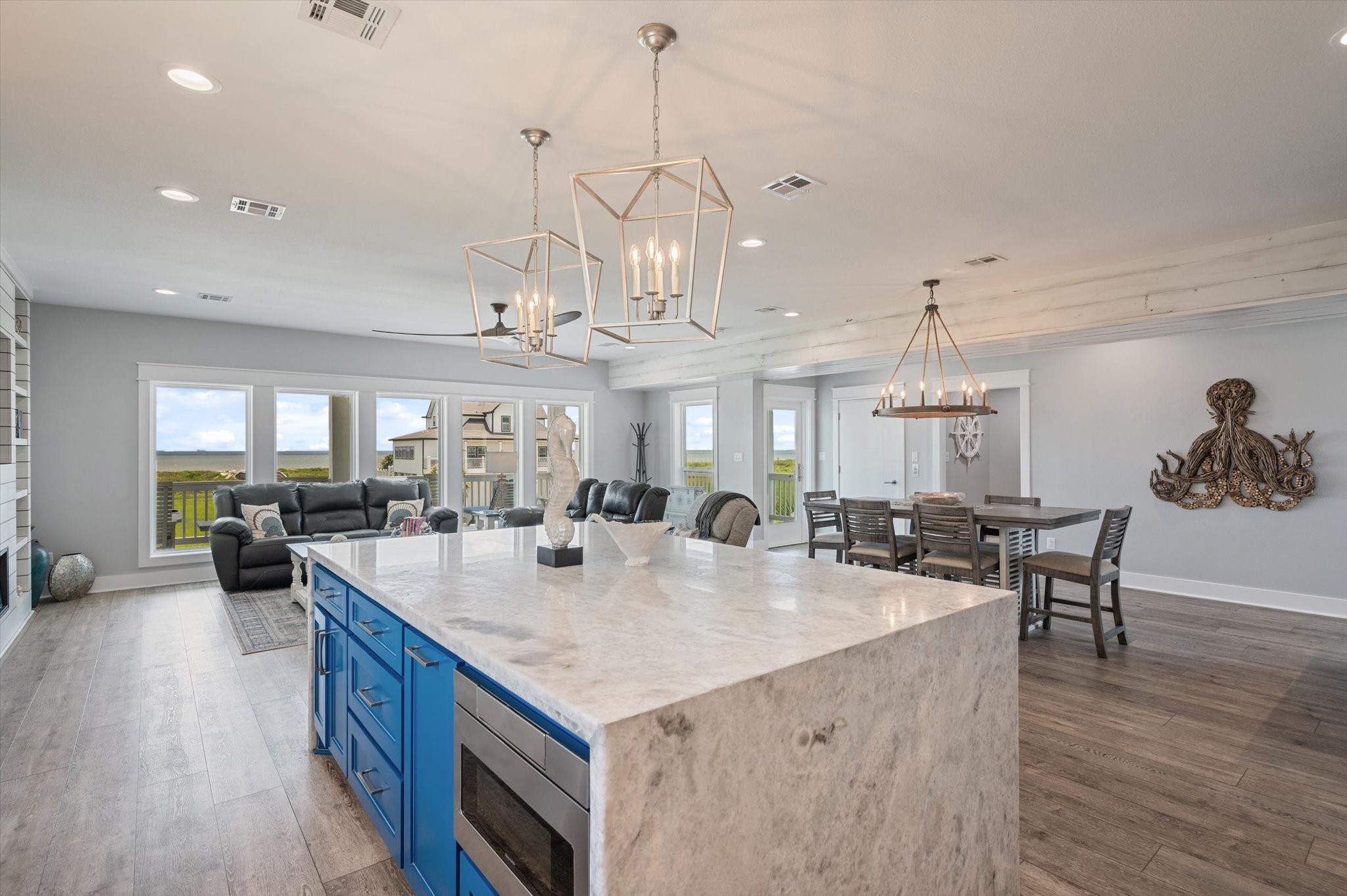 3701 Biscayne Beach Road Port Bolivar, TX 77650 - Photo 26 of 50 a view of a dining room and livingroom with furniture wooden floor a chandelier