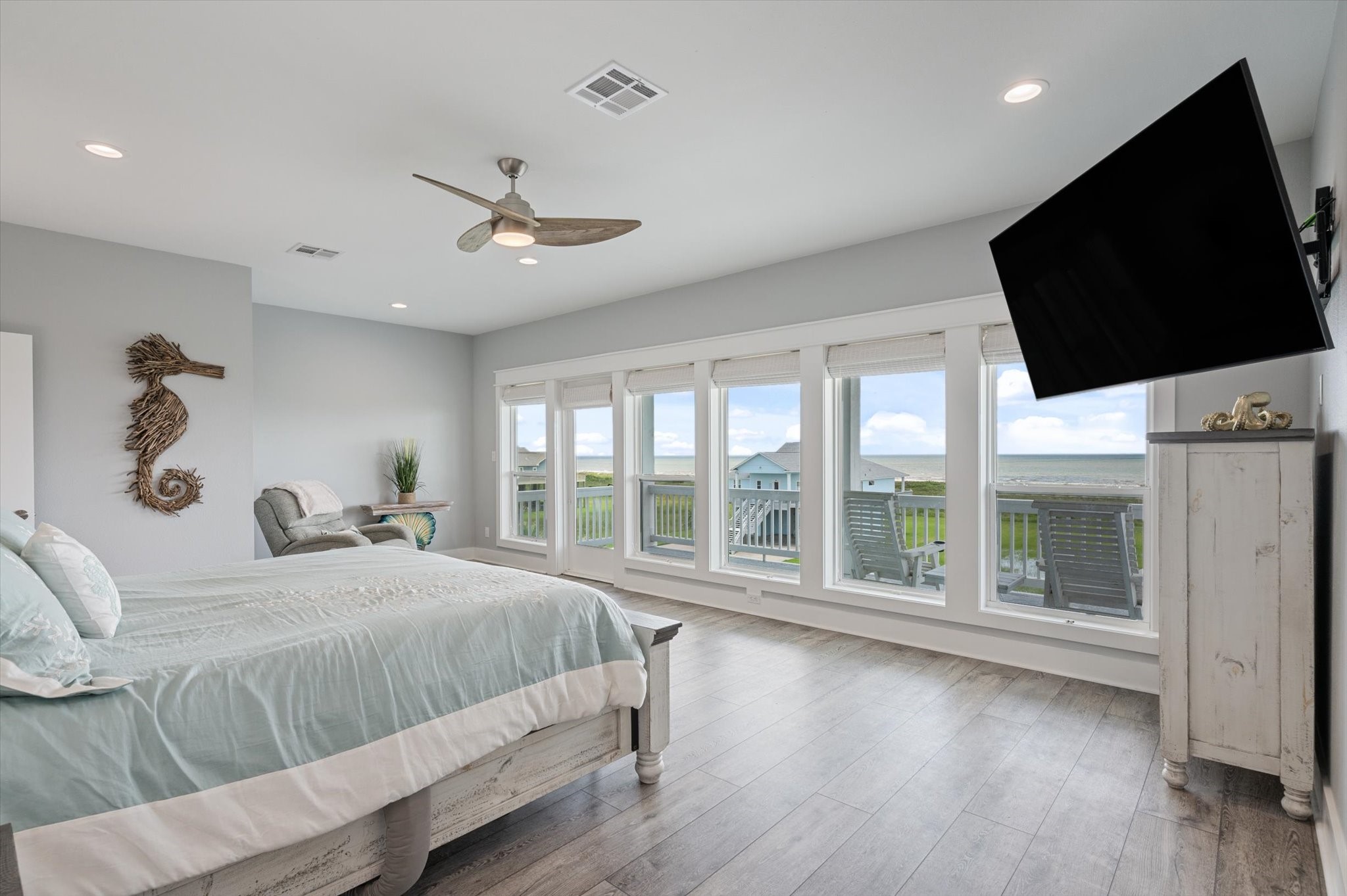 3701 Biscayne Beach Road Port Bolivar, TX 77650 - Photo 32 of 50 a bedroom with a large bed and a flat tv screen on dresser