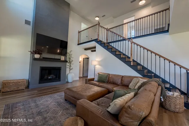 a living room with furniture a flat screen tv and a fireplace