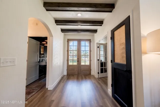 a view of hallway with wooden floor and stairs