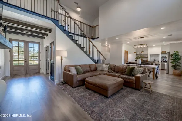 a living room with furniture and wooden floor