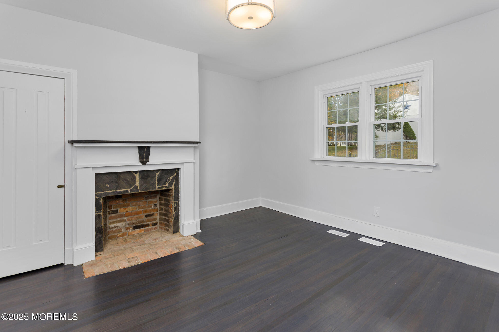 36 Chest-Georgetown Road Columbus, NJ 08022 - Photo 13 of 56 an empty room with wooden floor a fireplace and windows