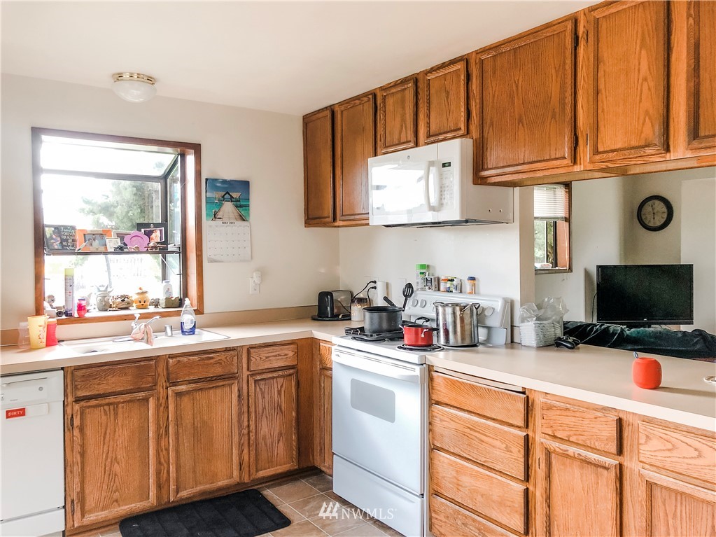 2121 Chestnut Street Everett, WA 98201 - Photo 14 of 21 a kitchen with cabinets appliances a sink and a window