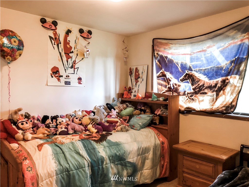 2121 Chestnut Street Everett, WA 98201 - Photo 17 of 21 a bed room with a bed and a couch