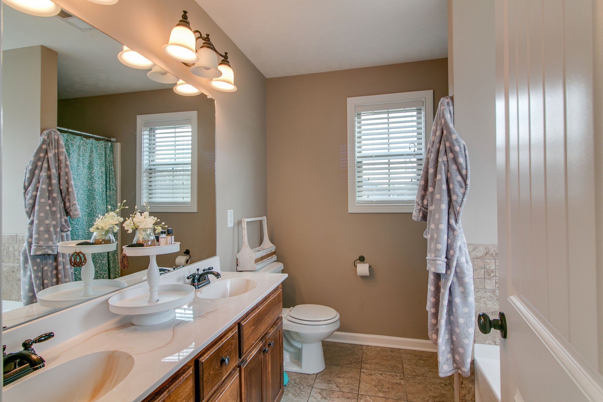 2312 River Road Clarksville, TN 37040 - Photo 10 of 25 a bathroom with a granite countertop sink a toilet and a mirror