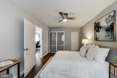 a bedroom with a large bed and a chandelier