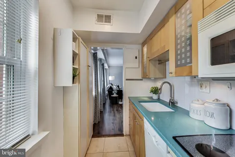 a kitchen with stainless steel appliances granite countertop a sink refrigerator and microwave