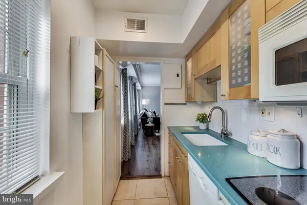 a kitchen with stainless steel appliances granite countertop a sink refrigerator and microwave