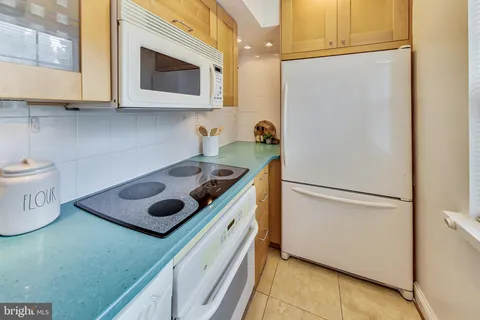 a kitchen with a sink cabinets and appliances