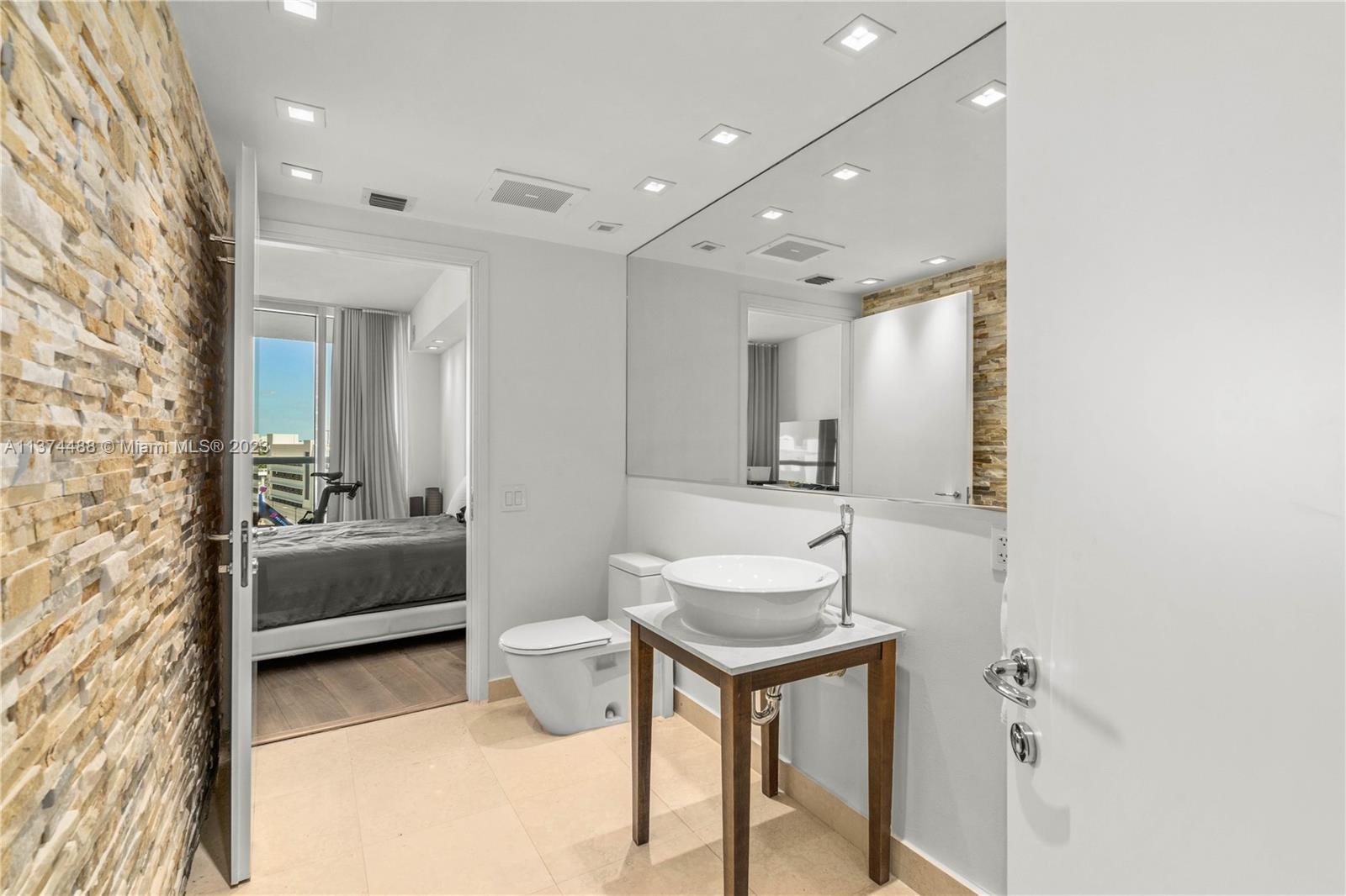 450 Alton Road, Unit 806 Miami Beach, FL 33139 - Photo 19 of 33 a spacious bathroom with a sink mirror and toilet