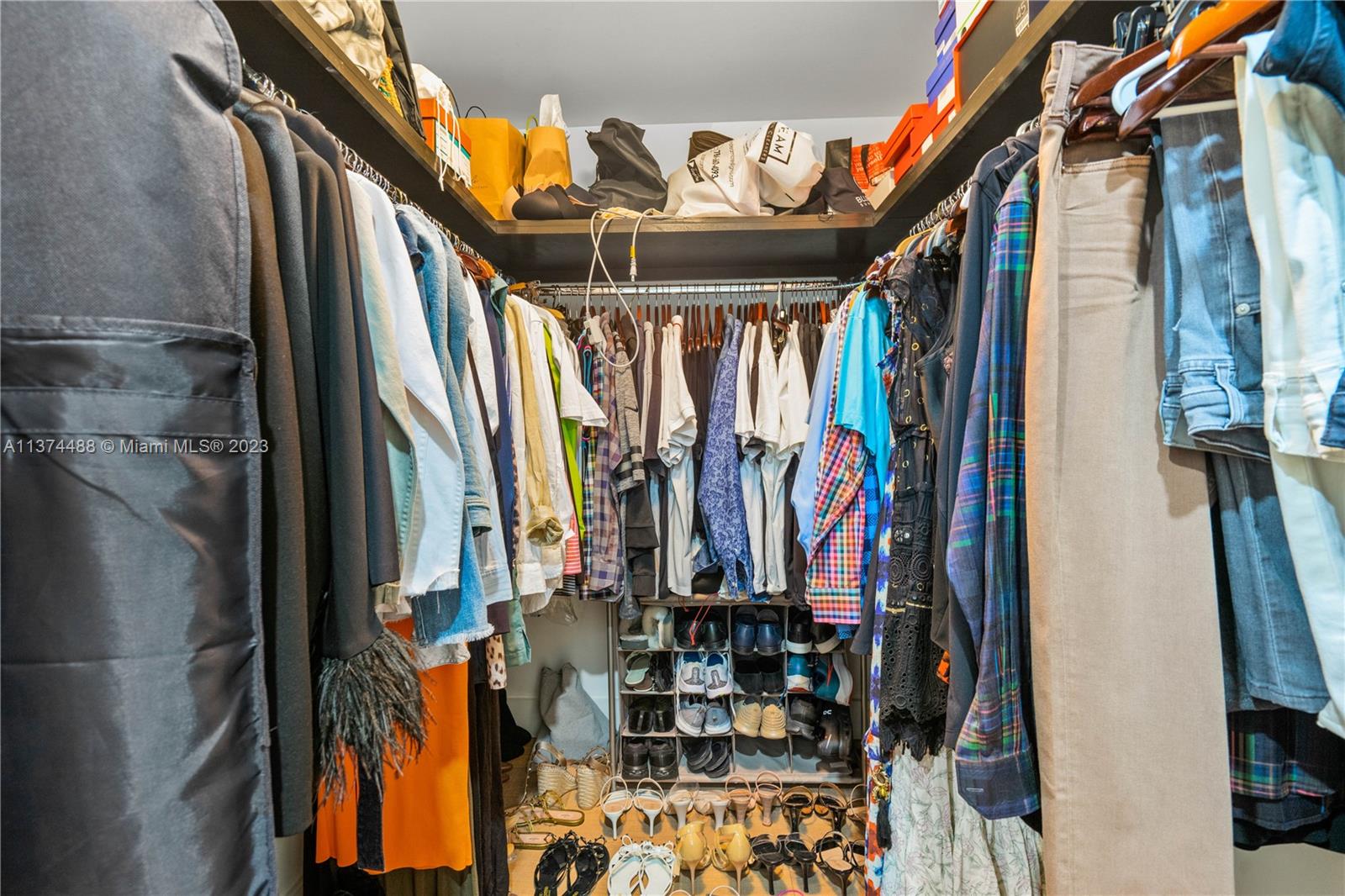 450 Alton Road, Unit 806 Miami Beach, FL 33139 - Photo 29 of 33 a view of walk in closet with clothes and shoes