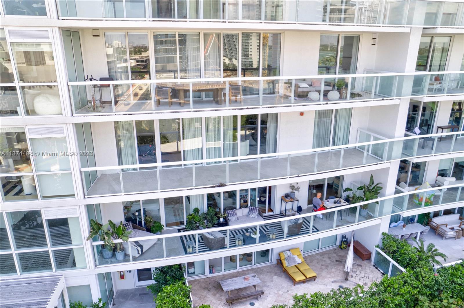 450 Alton Road, Unit 806 Miami Beach, FL 33139 - Photo 9 of 33 a front view of a building with glass windows and plants