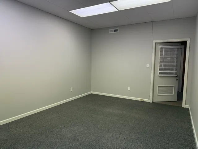 a view of an empty room and closet area