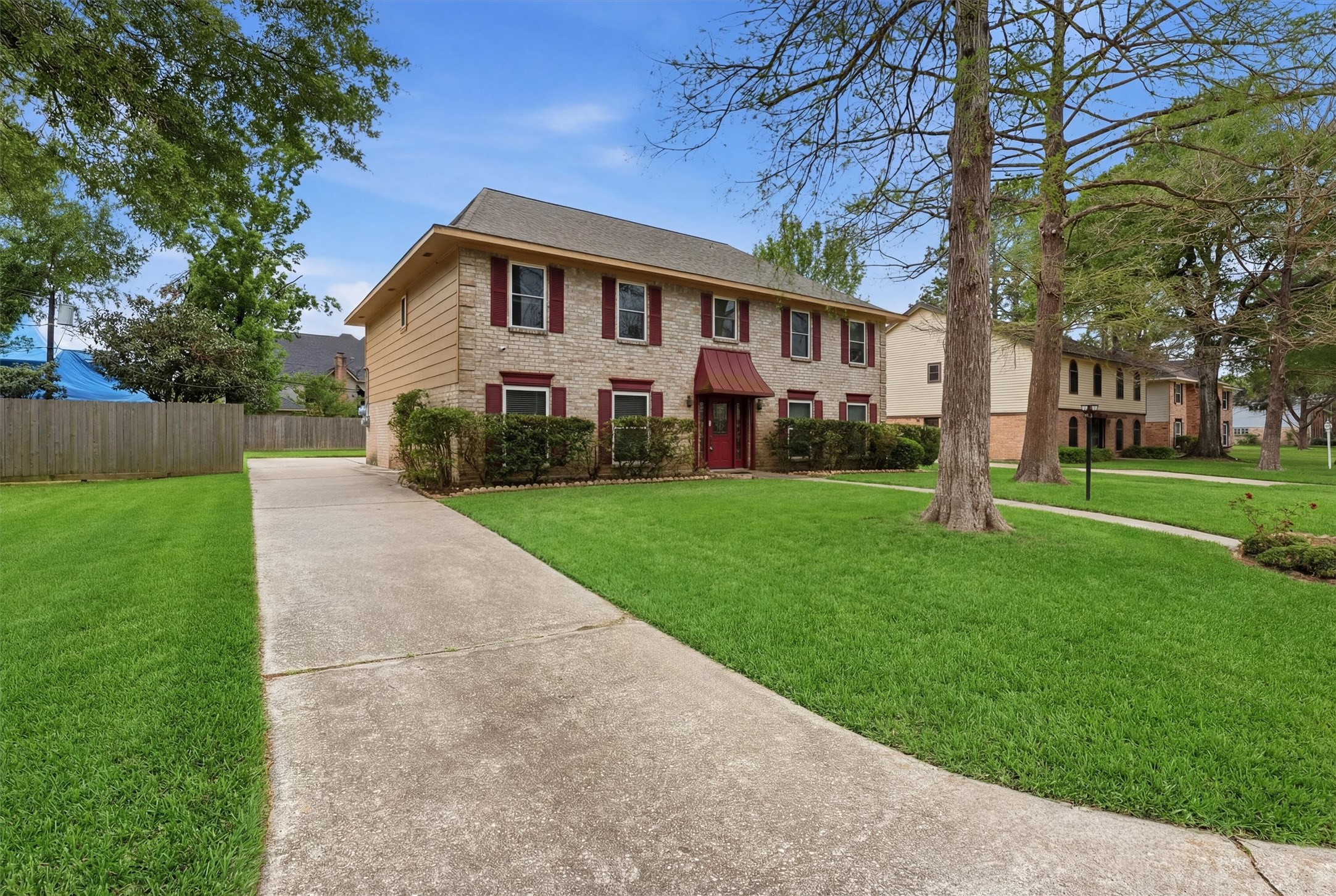 8115 Theisswood Road Spring, TX 77379 - Photo 2 of 36 a front view of house with yard and green space