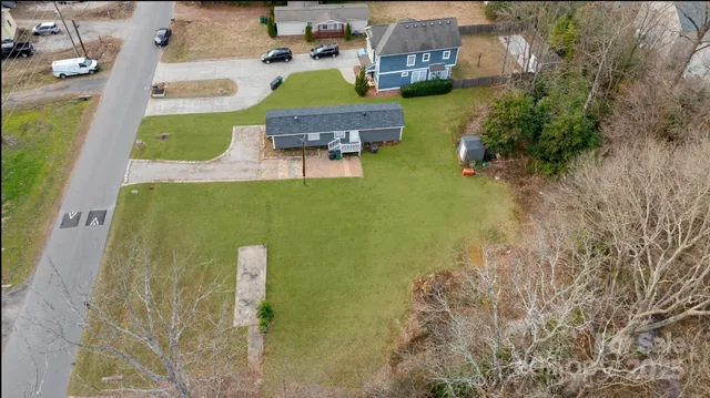 an aerial view of a house with a swimming pool