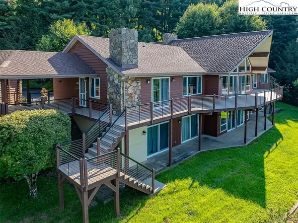 an aerial view of a house with swimming pool and sitting area