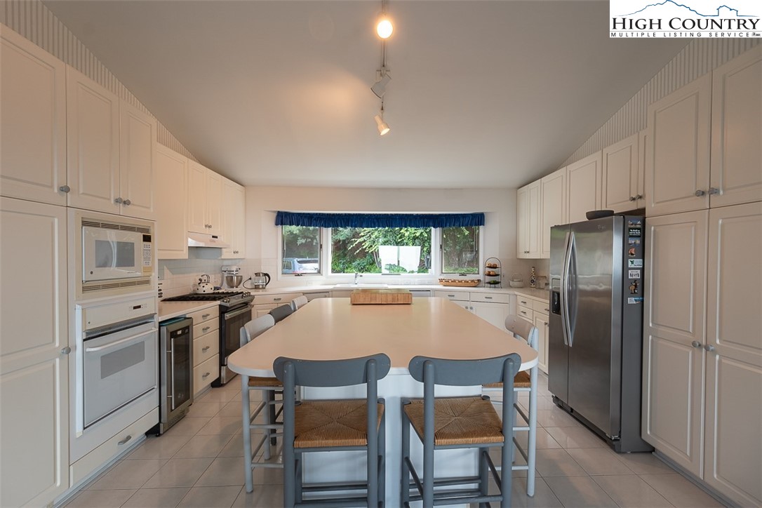 148 Chestnut Ridge Lane Glade Valley, NC 28627 - Photo 15 of 50 a kitchen with a stove a refrigerator and a stove top oven