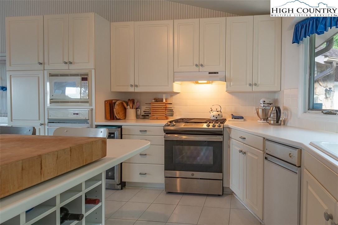 148 Chestnut Ridge Lane Glade Valley, NC 28627 - Photo 16 of 50 a kitchen with stainless steel appliances white cabinets and a sink