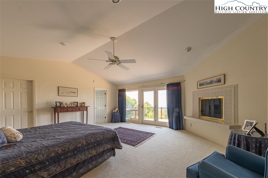 148 Chestnut Ridge Lane Glade Valley, NC 28627 - Photo 18 of 50 a bedroom with a bed and dresser with chair