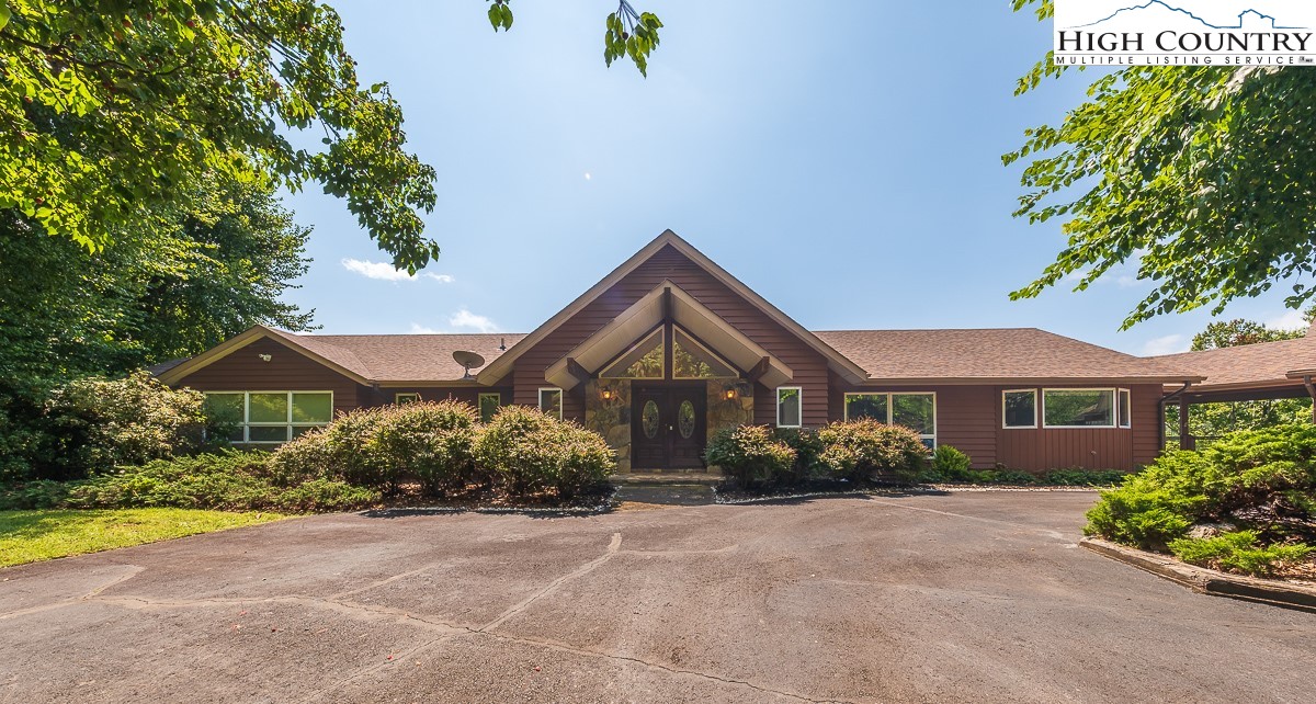 148 Chestnut Ridge Lane Glade Valley, NC 28627 - Photo 2 of 50 a front view of a house with a yard and potted plants