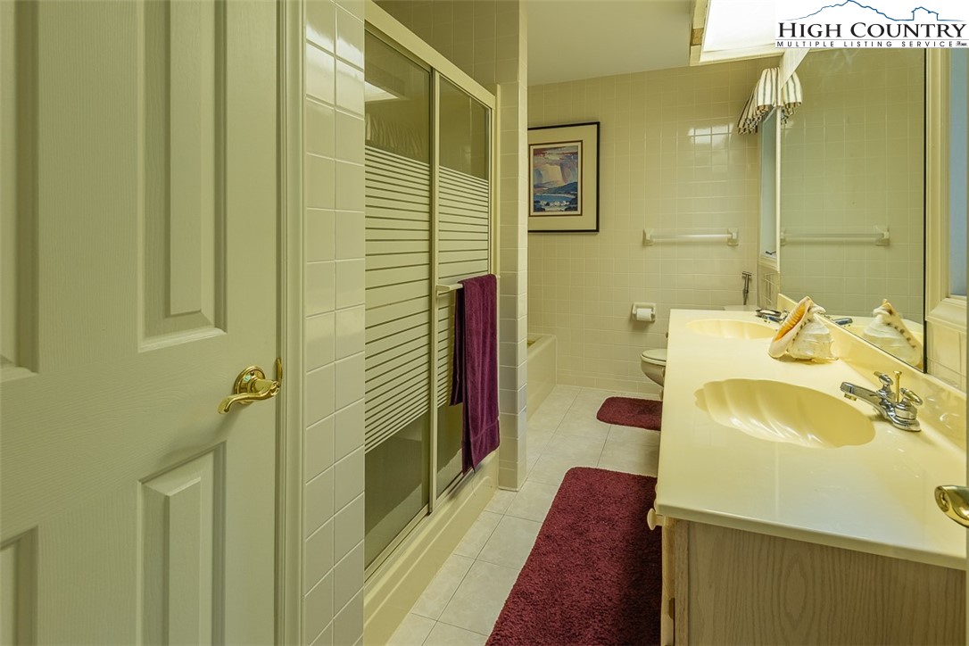 148 Chestnut Ridge Lane Glade Valley, NC 28627 - Photo 23 of 50 a bathroom with a sink and a shower
