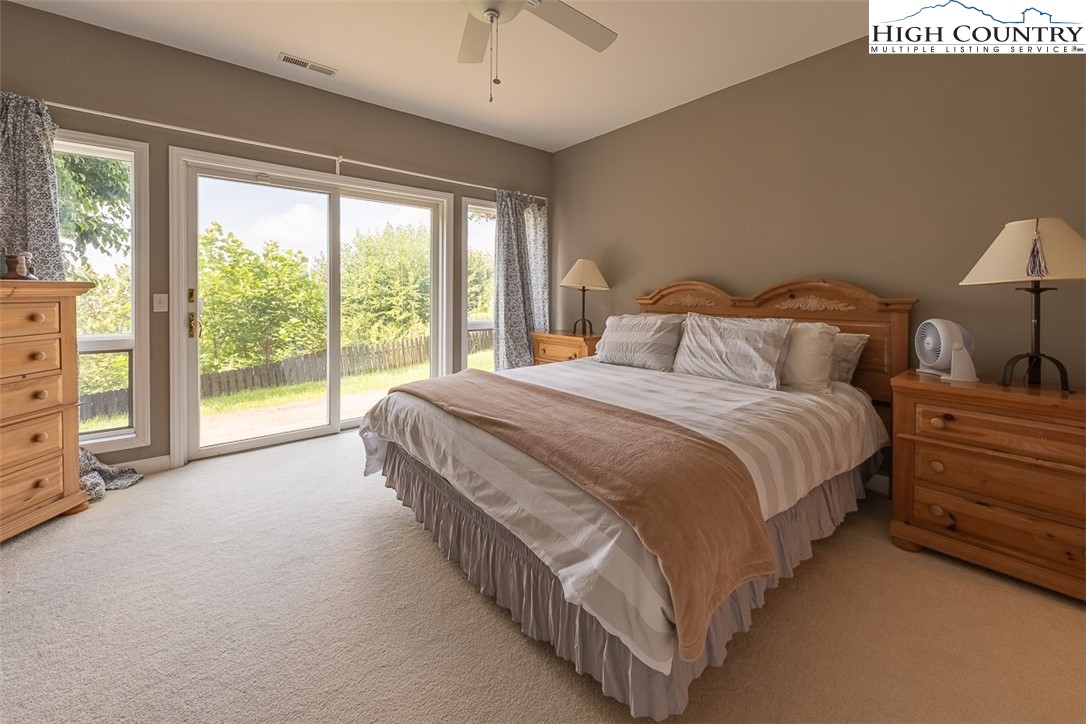 148 Chestnut Ridge Lane Glade Valley, NC 28627 - Photo 29 of 50 a spacious bedroom with a bed and a large window