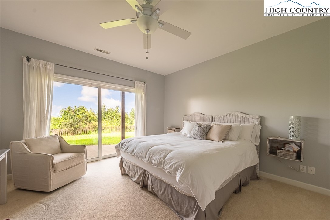 148 Chestnut Ridge Lane Glade Valley, NC 28627 - Photo 33 of 50 a bedroom with a large bed and a couch