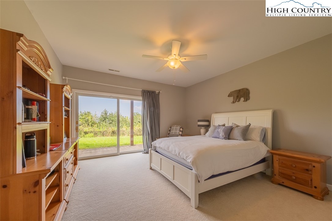 148 Chestnut Ridge Lane Glade Valley, NC 28627 - Photo 35 of 50 a bedroom with a bed and a chandelier