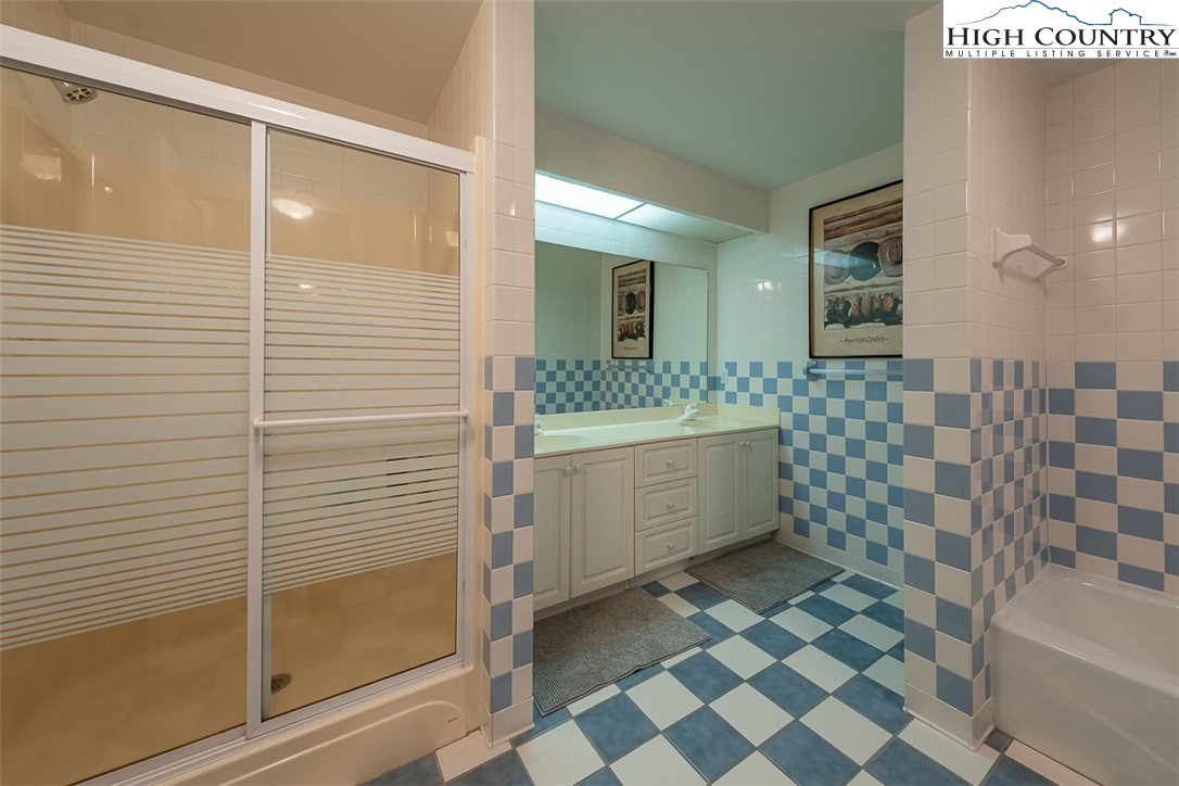 148 Chestnut Ridge Lane Glade Valley, NC 28627 - Photo 36 of 50 a bathroom with a sink a toilet a mirror and shower