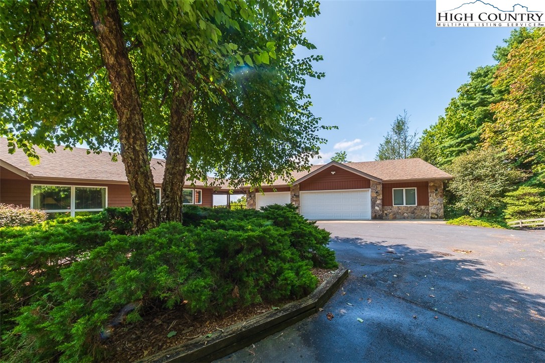 148 Chestnut Ridge Lane Glade Valley, NC 28627 - Photo 38 of 50 a front view of a house with a garden