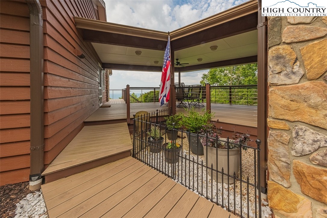 148 Chestnut Ridge Lane Glade Valley, NC 28627 - Photo 4 of 50 a view of a balcony with chairs and wooden floor